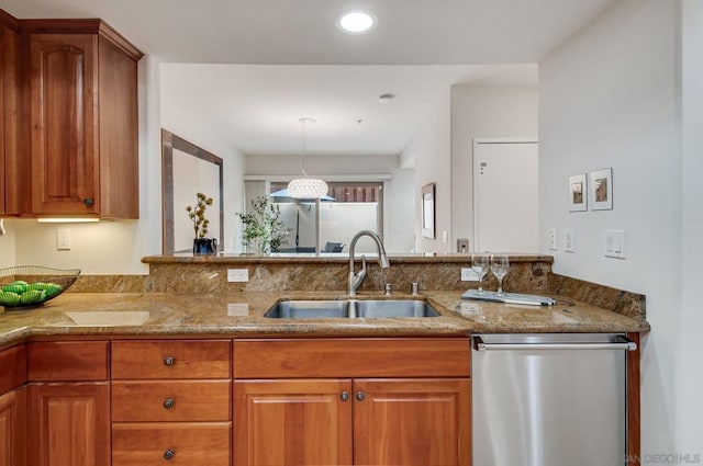 kitchen featuring sink, light stone countertops, hanging light fixtures, and dishwasher