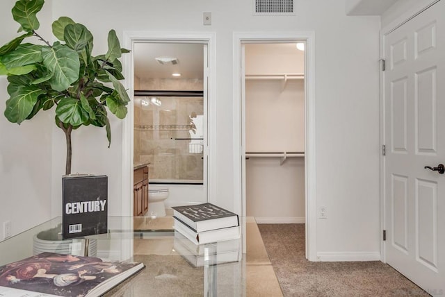 bathroom featuring vanity, a shower with shower door, and toilet