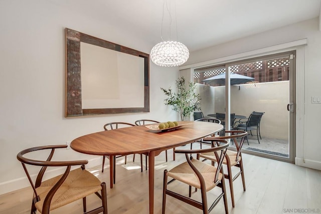 dining space with light hardwood / wood-style flooring