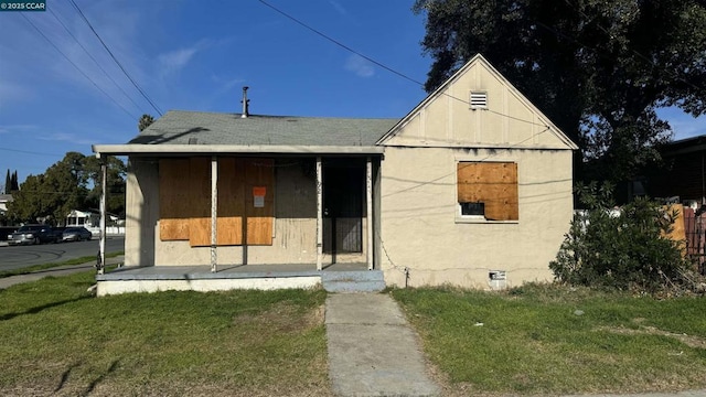 view of front of home with a front lawn and a porch