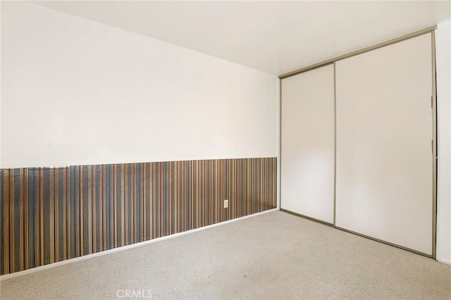 unfurnished bedroom featuring a closet and carpet flooring