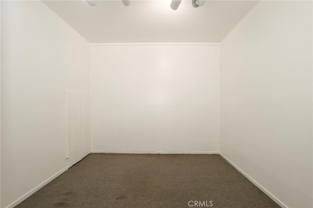 unfurnished room with baseboards, carpet, and vaulted ceiling