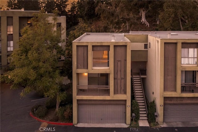 exterior space with a garage and stairway
