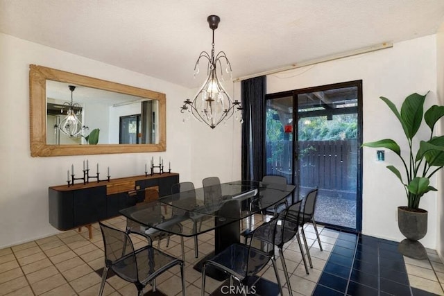 dining space featuring a notable chandelier and dark tile patterned floors