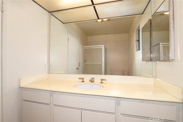 bathroom with an enclosed shower and vanity