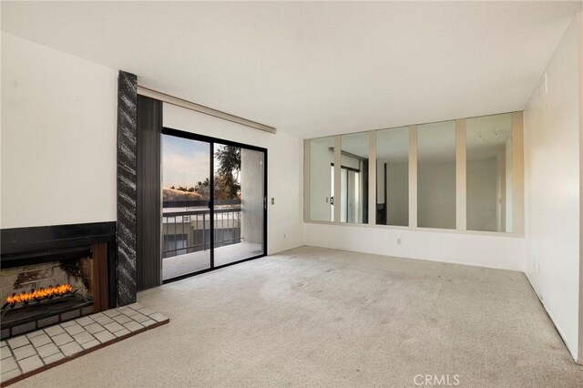 unfurnished living room with carpet floors and a multi sided fireplace
