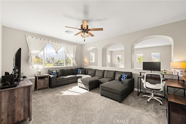 carpeted living room featuring ceiling fan