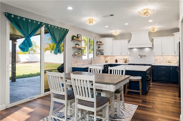 dining room with dark hardwood / wood-style flooring and sink