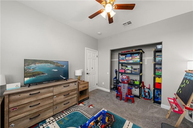 recreation room with ceiling fan and carpet flooring