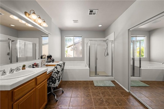 bathroom featuring vanity, tile patterned floors, and separate shower and tub