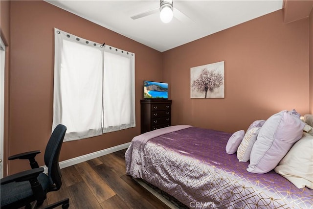 bedroom with dark hardwood / wood-style floors and ceiling fan