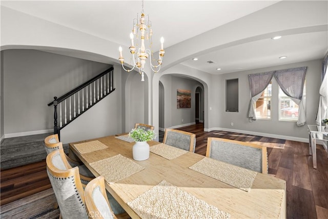 dining room featuring dark wood-type flooring and a chandelier