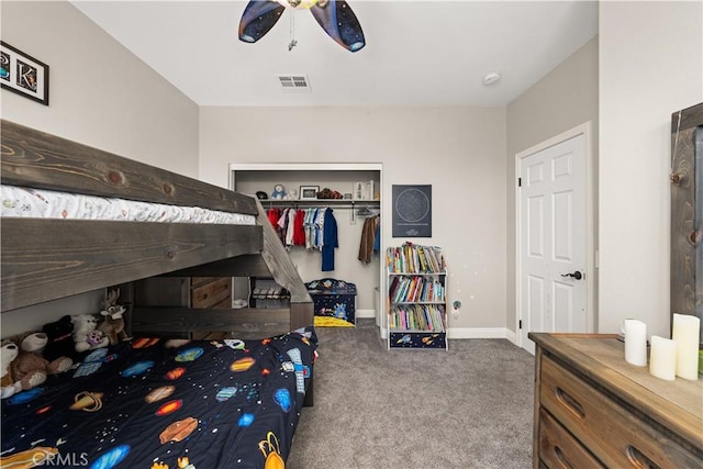 carpeted bedroom with ceiling fan and a closet