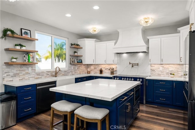 kitchen featuring black dishwasher, custom range hood, white cabinets, and blue cabinetry