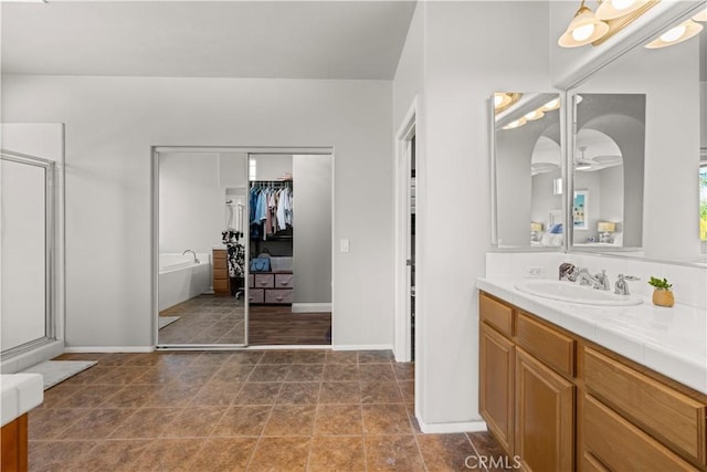 bathroom with vanity, separate shower and tub, and tile patterned floors