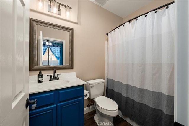 bathroom featuring vanity, hardwood / wood-style flooring, and toilet