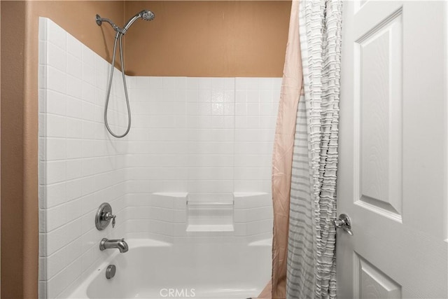 bathroom featuring shower / bath combo with shower curtain