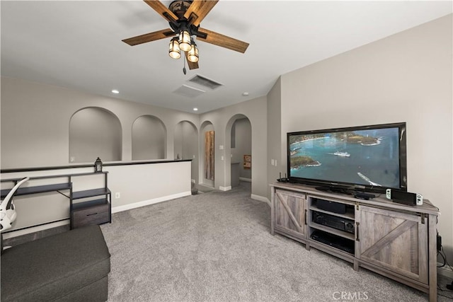 living room featuring ceiling fan and carpet