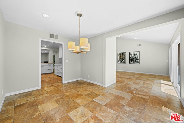 unfurnished dining area featuring vaulted ceiling and an inviting chandelier