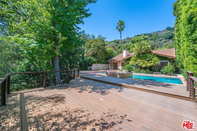 wooden deck featuring a fenced in pool