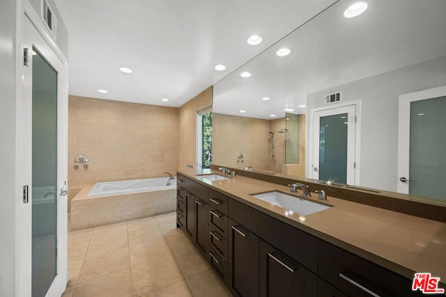 bathroom featuring tile patterned floors, plus walk in shower, and vanity