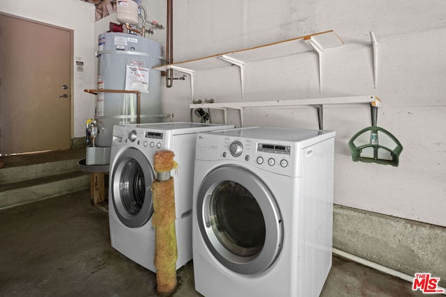 laundry area featuring washer and clothes dryer and strapped water heater