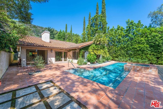 view of swimming pool with an in ground hot tub and a patio