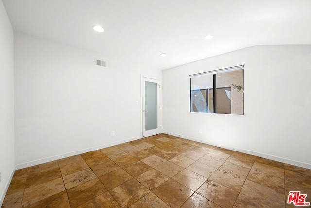 empty room with lofted ceiling