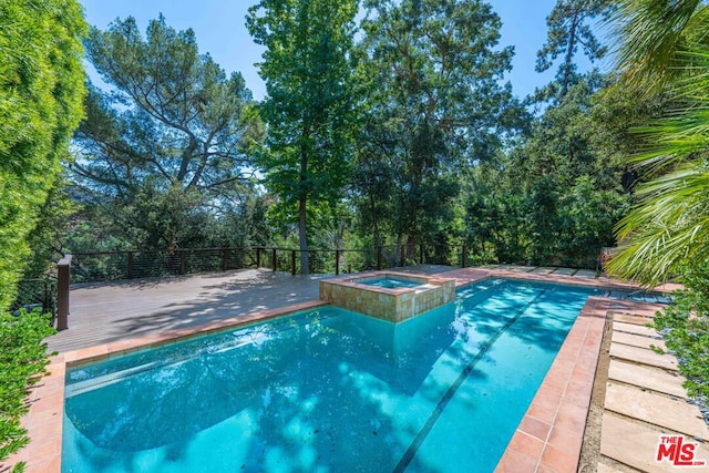 view of swimming pool with an in ground hot tub and a wooden deck