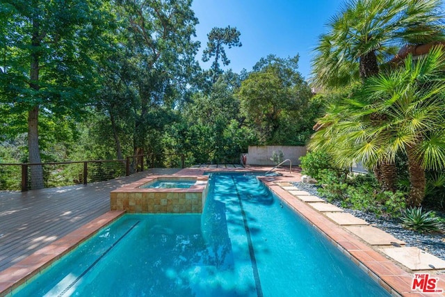 view of pool with a deck and an in ground hot tub