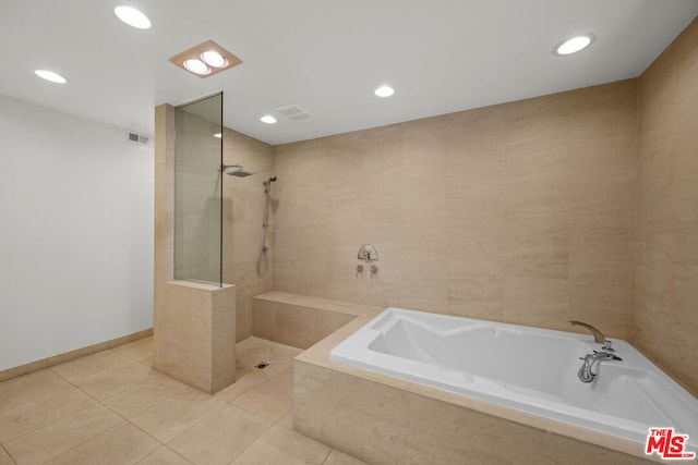 bathroom with separate shower and tub and tile patterned floors