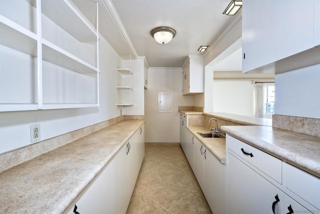 kitchen with light tile patterned floors, sink, and white cabinets