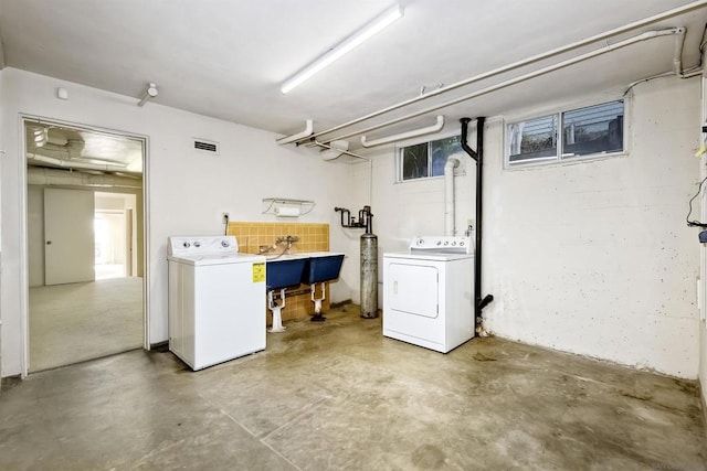 clothes washing area featuring washer and dryer