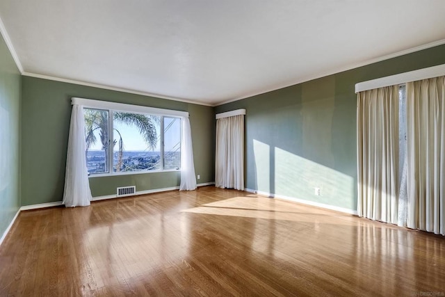 spare room with hardwood / wood-style flooring and ornamental molding