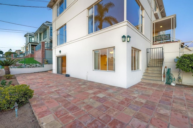 view of side of home with a patio area