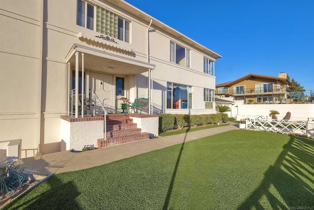 back of house featuring a lawn