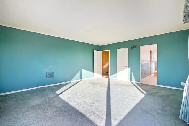 unfurnished bedroom featuring connected bathroom and dark carpet