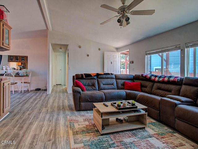 living room with vaulted ceiling, wood-type flooring, and ceiling fan