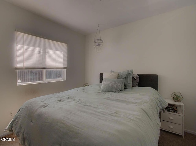 bedroom featuring dark colored carpet