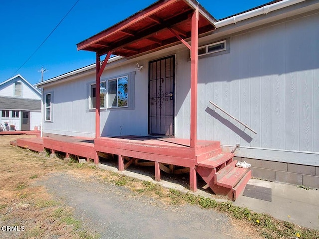 property entrance with a deck