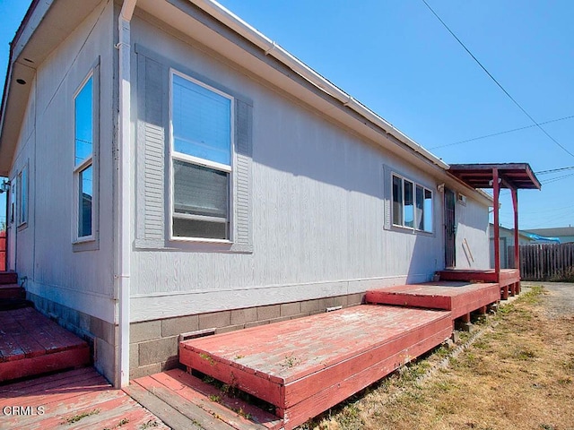 view of property exterior featuring a wooden deck