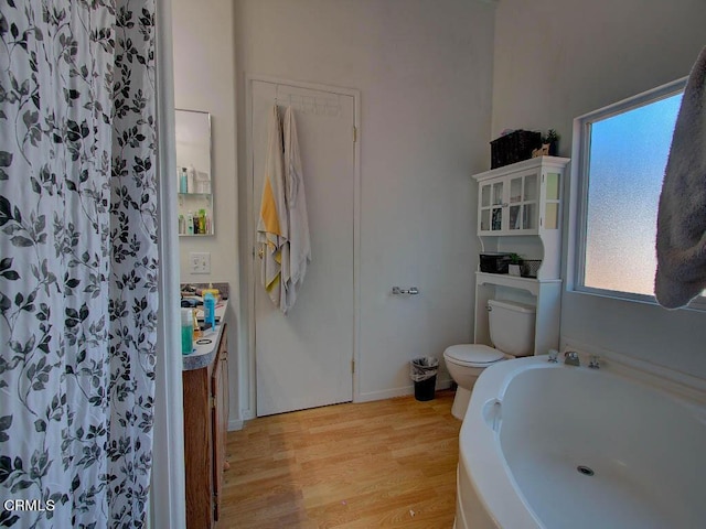 bathroom featuring hardwood / wood-style floors and toilet