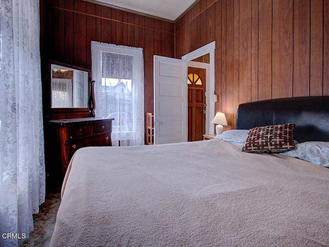 bedroom featuring wooden walls