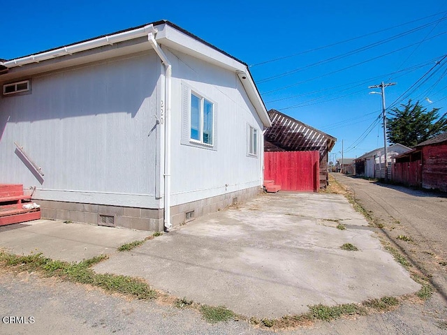 view of side of home with a patio area