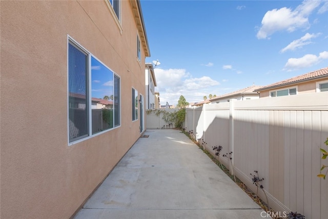 view of property exterior featuring a patio area, a fenced backyard, and stucco siding