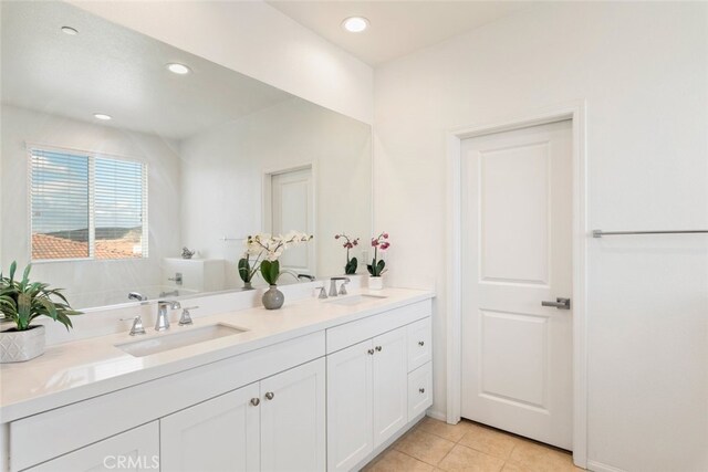 bathroom featuring a tub to relax in, tile patterned floors, and vanity