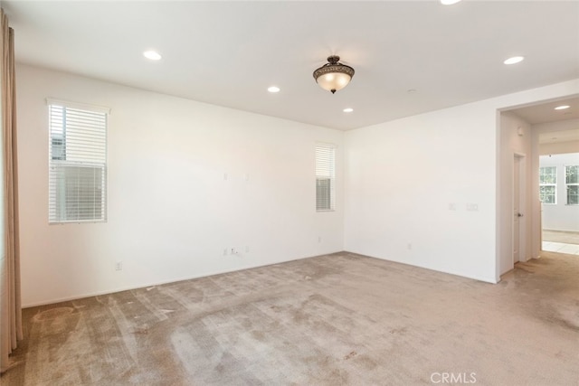 unfurnished room with recessed lighting and light colored carpet