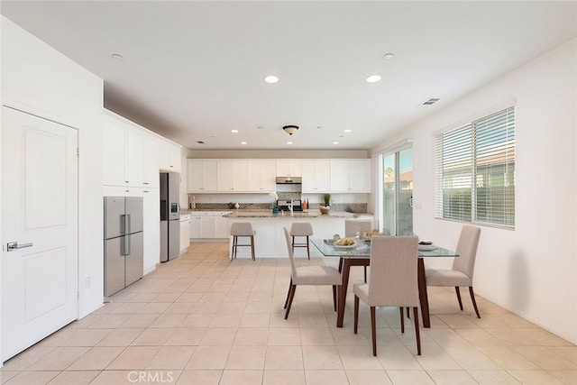 tiled dining room with sink