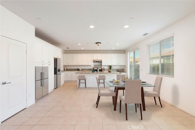 dining space with light tile patterned floors, visible vents, and recessed lighting