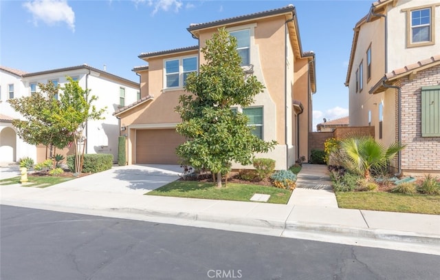 view of front of property with a garage, concrete driveway, and stucco siding